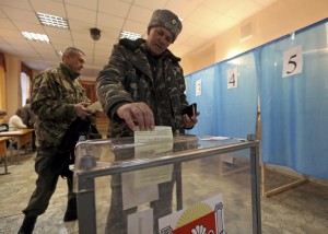 A Cossak casts his ballot during the referendum on the status of Ukraine's Crimea region at a polling station in Simferopol