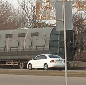 Ті ж самі вантажівки вже з вагонами і колесами рухаються на виїзд з Бердянська по Мелітопольському шосе, 8 березня 2023 року